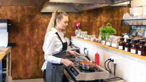 blonde woman cooking in a large kitchen